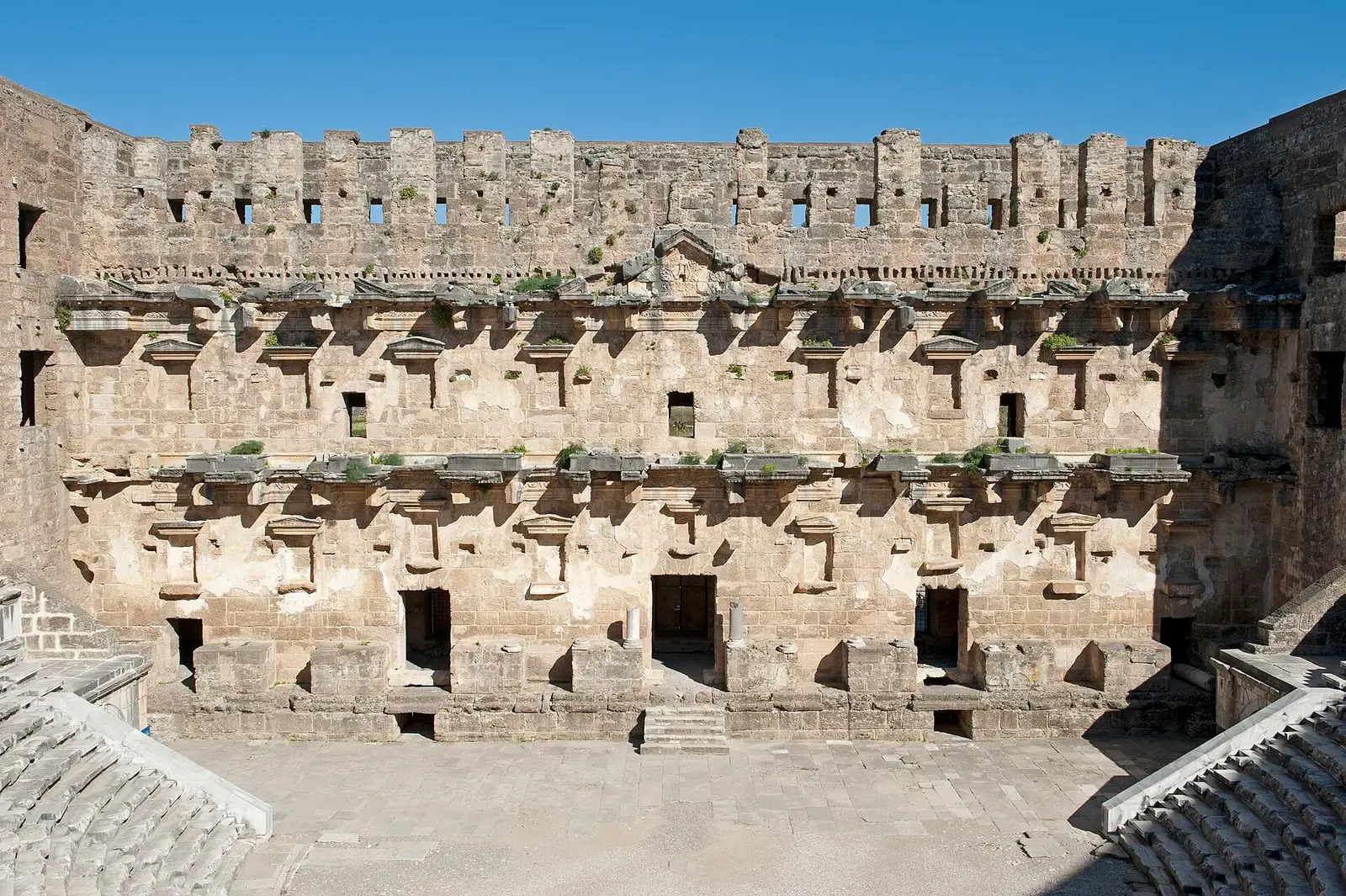 De hoge toneelwand van het theater van Aspendos met nissen en vensters